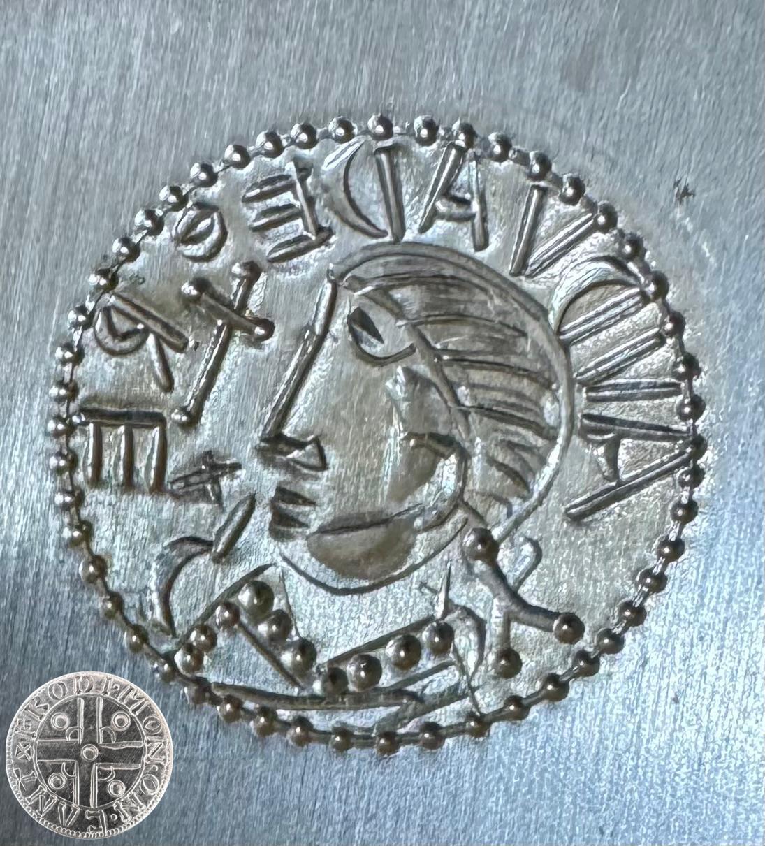 Close-up of a hand-engraved medieval coin die face